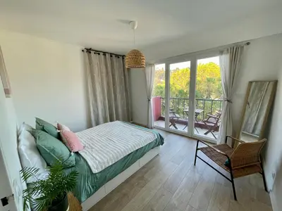 a bedroom with a bed and a balcony at Bright appartment with view in Cagnes-sur-Mer