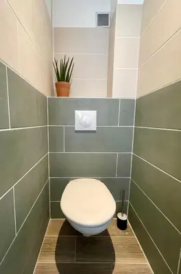 a bathroom with a white toilet in a room at Bright appartment with view in Cagnes-sur-Mer