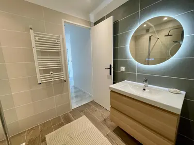 a bathroom with a sink and a mirror at Bright appartment with view in Cagnes-sur-Mer