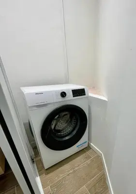 a washing machine in a corner of a room at Bright appartment with view in Cagnes-sur-Mer