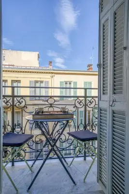 a balcony with two chairs and a table on a balcony at Sublime, modern, balconies, a/c, refurbished in Nice