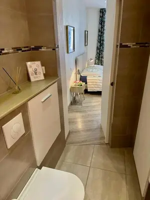 a bathroom with a toilet and a room with a bed at Sublime, modern, balconies, a/c, refurbished in Nice