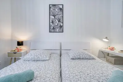 a bedroom with two beds and a picture on the wall at Sublime, modern, balconies, a/c, refurbished in Nice