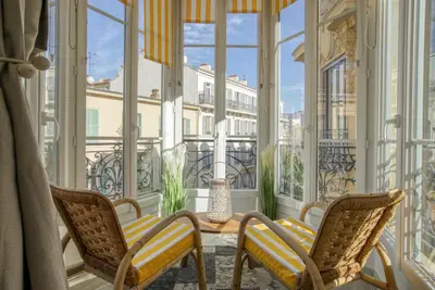 a room with two chairs and a table on a balcony at Sublime, modern, balconies, a/c, refurbished in Nice