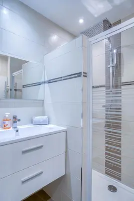 a white bathroom with a sink and a shower at Sublime, modern, balconies, a/c, refurbished in Nice
