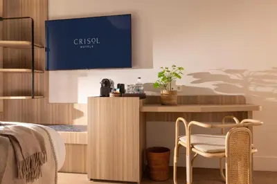 a hotel room with a bed and a table at Crisol Mozart in Nice