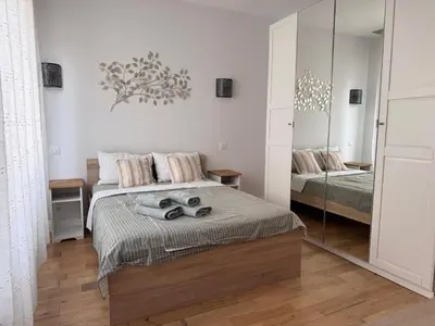 a bedroom with two beds and a mirror at Oscar in Nice