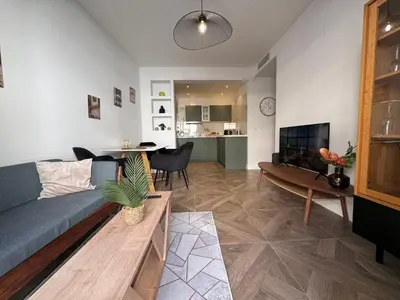 a living room with a couch and a table at Oscar in Nice