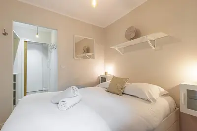 a bedroom with a large white bed with white pillows at Lovely 1 Bdr Port Area in Nice