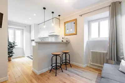 a kitchen with two bar stools in a room at Lovely 1 Bdr Port Area in Nice