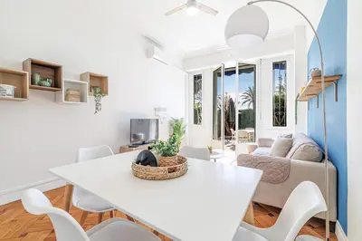 a living room with a white table and chairs at Promenade des Anglais 2 Bdr Large Terrace in Nice