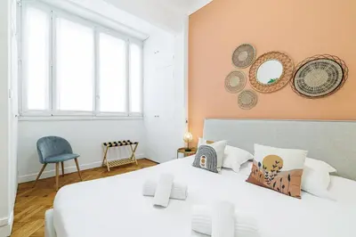 a bedroom with two beds and a chair at Promenade des Anglais 2 Bdr Large Terrace in Nice