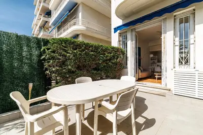 a white table and chairs on a patio at Promenade des Anglais 2 Bdr Large Terrace in Nice