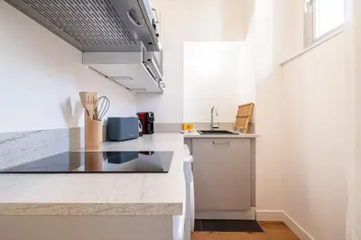 a kitchen with a sink and a counter top at Charming City Center Studio 104 in Nice