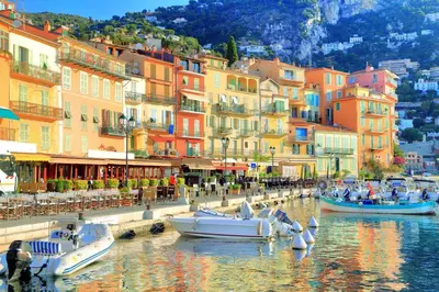 a group of boats in a body of water with buildings at Cosy Home in Villefranche-sur-Mer