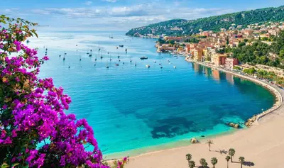 a view of a beach with people in the water at Cosy Home in Villefranche-sur-Mer