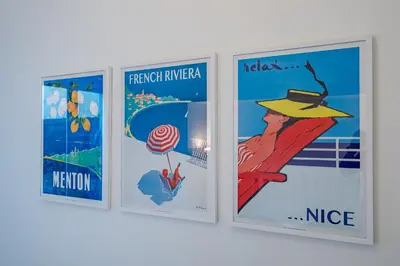 a group of four posters hanging on a wall at Promenade des Anglais - 2 chambres - Jardin in Nice