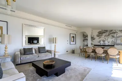a living room with a couch and a table at VILLA BELLE VUE VI4394 By Riviera Holiday Homes in Villefranche-sur-Mer