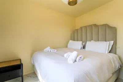 a bedroom with a large white bed with towels on it at VILLA BELLE VUE VI4394 By Riviera Holiday Homes in Villefranche-sur-Mer