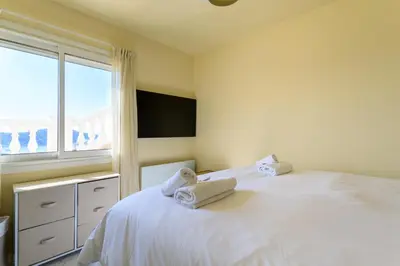 a bedroom with a white bed with towels on it at VILLA BELLE VUE VI4394 By Riviera Holiday Homes in Villefranche-sur-Mer