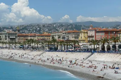 a group of people on a beach near the water at Cœur d'Azur Appartement in Nice