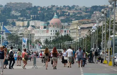 a group of people walking down a city street at Cœur d'Azur Appartement in Nice