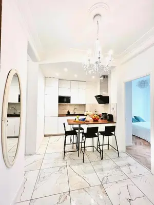 a kitchen and dining room with a table and chairs at Cœur d'Azur Appartement in Nice