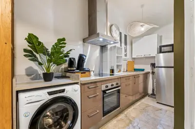 a kitchen with a washing machine and a washer at Nice Renting - FODERE - Charm & Comfort 2P Heart of Nice - AC & WiFi in Nice