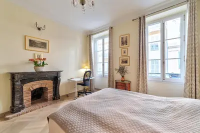 a bedroom with a fireplace and a bed at Elegant apartment in Nice centre with grand terrace in Nice