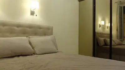 a bedroom with a bed with white pillows and a mirror at Elegant apartment in Nice centre with grand terrace in Nice