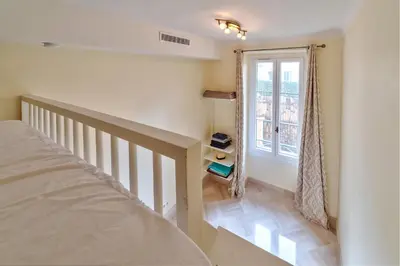 a bedroom with a bed and a window at Elegant apartment in Nice centre with grand terrace in Nice