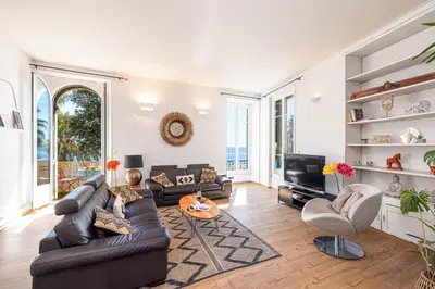 a living room with a couch and a tv at MY CASA - ETATS UNIS 892 - Spacious flat on Sea front w AC in Nice