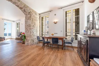 an open living room with a table and chairs at MY CASA - ETATS UNIS 892 - Spacious flat on Sea front w AC in Nice