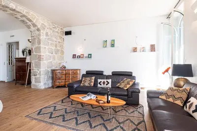 a living room with a leather couch and a table at MY CASA - ETATS UNIS 892 - Spacious flat on Sea front w AC in Nice
