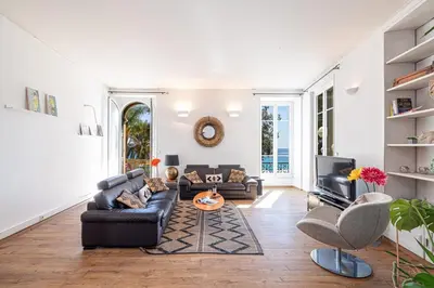 a living room with a couch and a tv at MY CASA - ETATS UNIS 892 - Spacious flat on Sea front w AC in Nice
