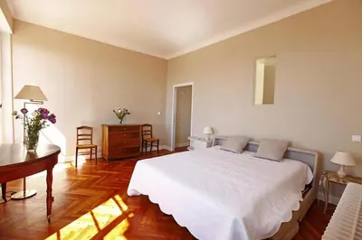 a bedroom with a large white bed and a desk at PALMERAIE - Magnifique appartement d'époque avec Vue Mer 4 personnes avec terrasse Le Port Nice in Nice