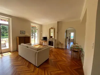 a living room with a couch and a table at PALMERAIE - Magnifique appartement d'époque avec Vue Mer 4 personnes avec terrasse Le Port Nice in Nice