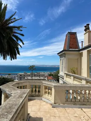 a view of the ocean from the balcony of a house at PALMERAIE - Magnifique appartement d'époque avec Vue Mer 4 personnes avec terrasse Le Port Nice in Nice