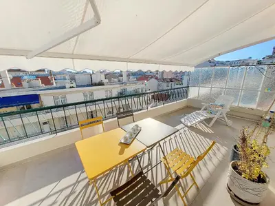 a balcony with a yellow table and chairs at Nestor&Jeeves - CIEL AZUR - Terrace in Nice