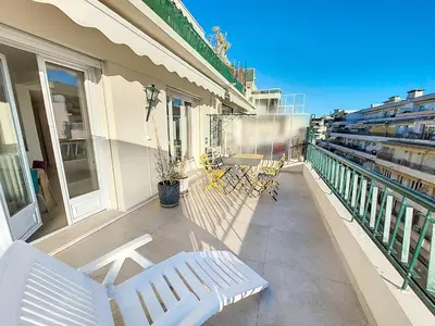 a balcony with white chairs and a table on a building at Nestor&Jeeves - CIEL AZUR - Terrace in Nice