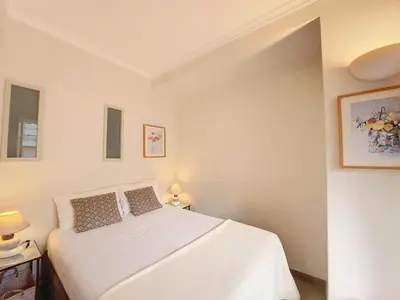 a bedroom with a white bed and two lamps at Nestor&Jeeves - BAIETA - Balcony in Nice