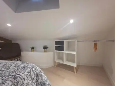 a bedroom with a bed and a white cabinet at Le Virenque in Nice