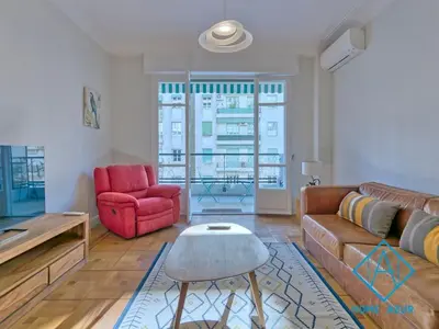 a living room with a couch and a red chair at NEW Luxurious apartment - Jean Medecin in Nice