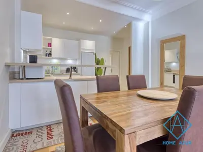 a dining room with a wooden table and chairs at NEW Luxurious apartment - Jean Medecin in Nice