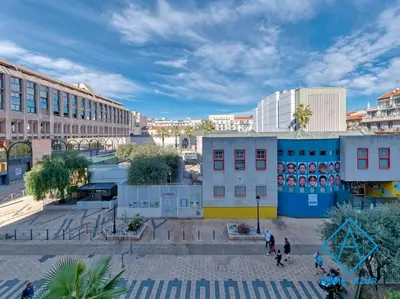 a group of people walking in a city with buildings at NEW Luxurious apartment - Jean Medecin in Nice