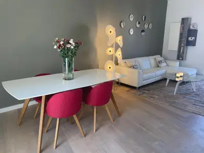 a living room with a table and pink chairs at Magenta MaMa - Comfort & Charm in Nice Carré d'Or - Near beach in Nice