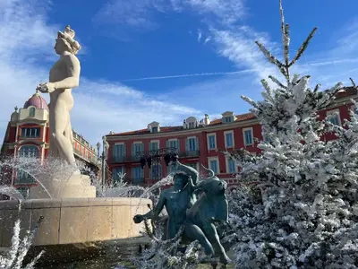a statue of two girls in a fountain in front of a building at Magenta MaMa - Comfort & Charm in Nice Carré d'Or - Near beach in Nice
