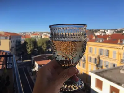 a hand holding a wine glass with a view at Magenta MaMa - Comfort & Charm in Nice Carré d'Or - Near beach in Nice