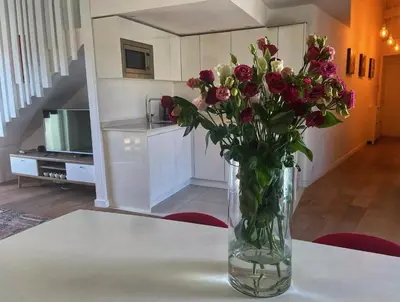 a vase filled with flowers sitting on a table at Magenta MaMa - Comfort & Charm in Nice Carré d'Or - Near beach in Nice