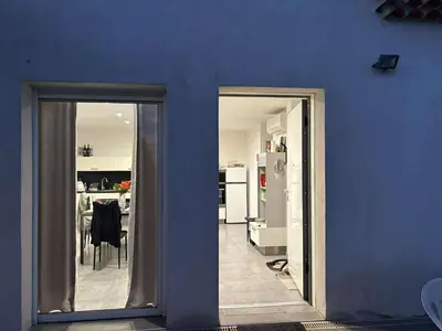 a blue wall with a kitchen and a dining room at Gite Mare e Montagne Drap 06 in Drap